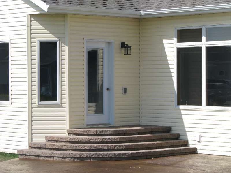 A house with stairs leading up to the front door