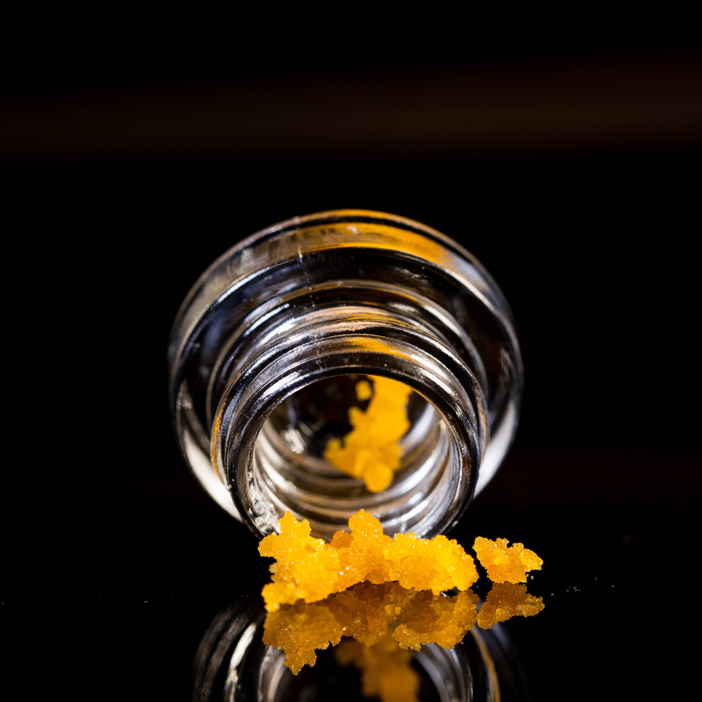 cannabis concentrate tumbling out of a glass dram