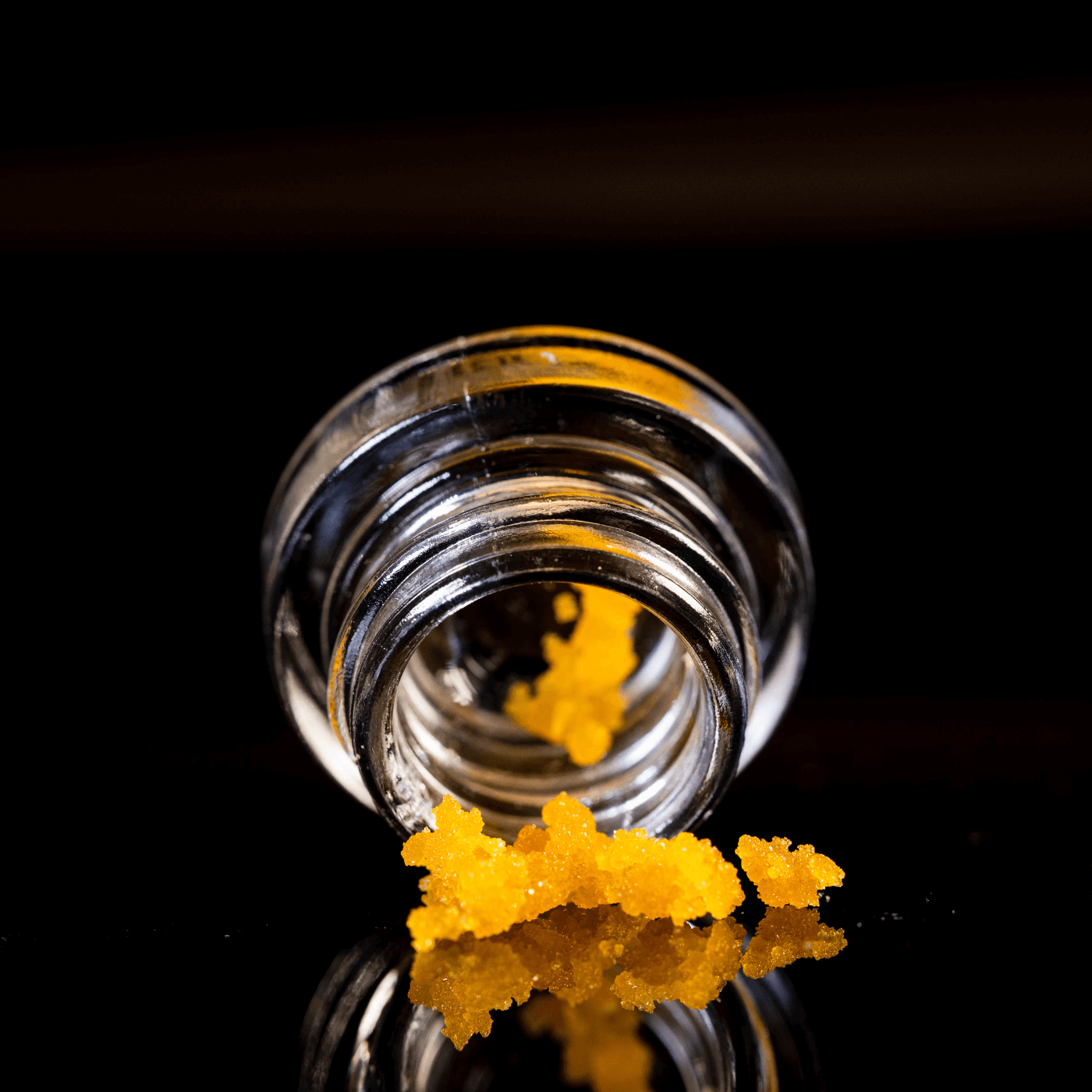 cannabis concentrate tumbling out of a glass dram