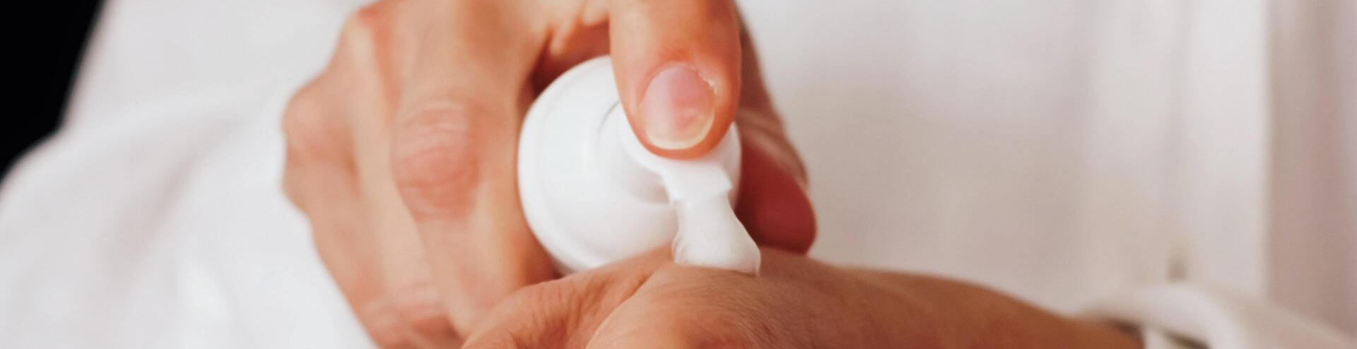 Closeup of hands applying lotion