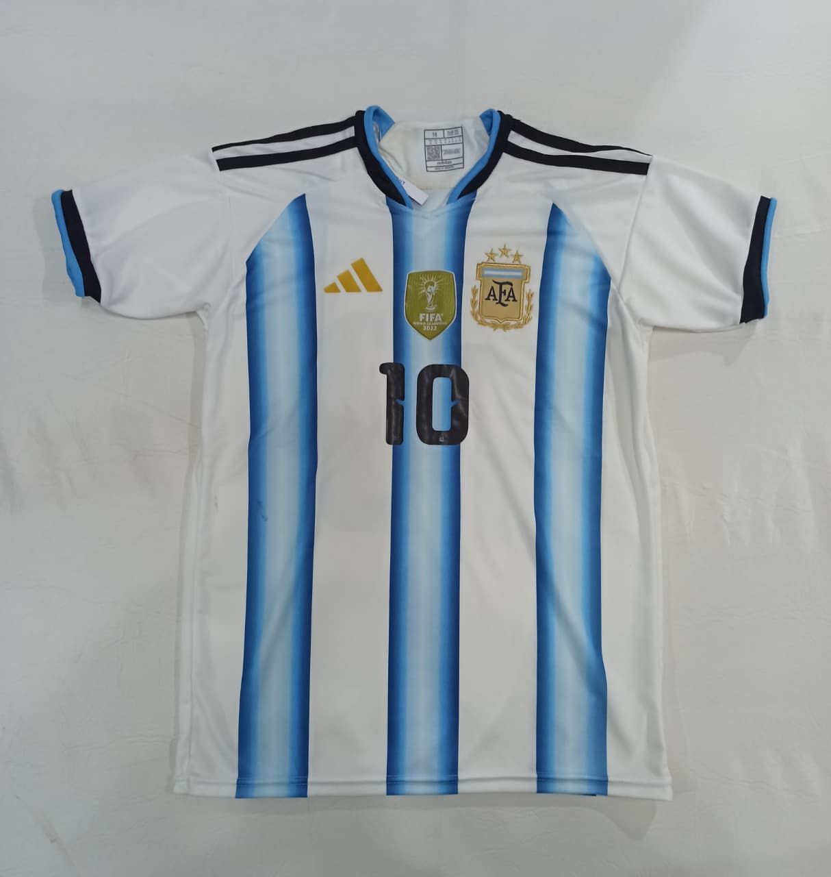 Camiseta de la selección argentina de fútbol, ​​blanca con rayas azul celeste y número 10.
