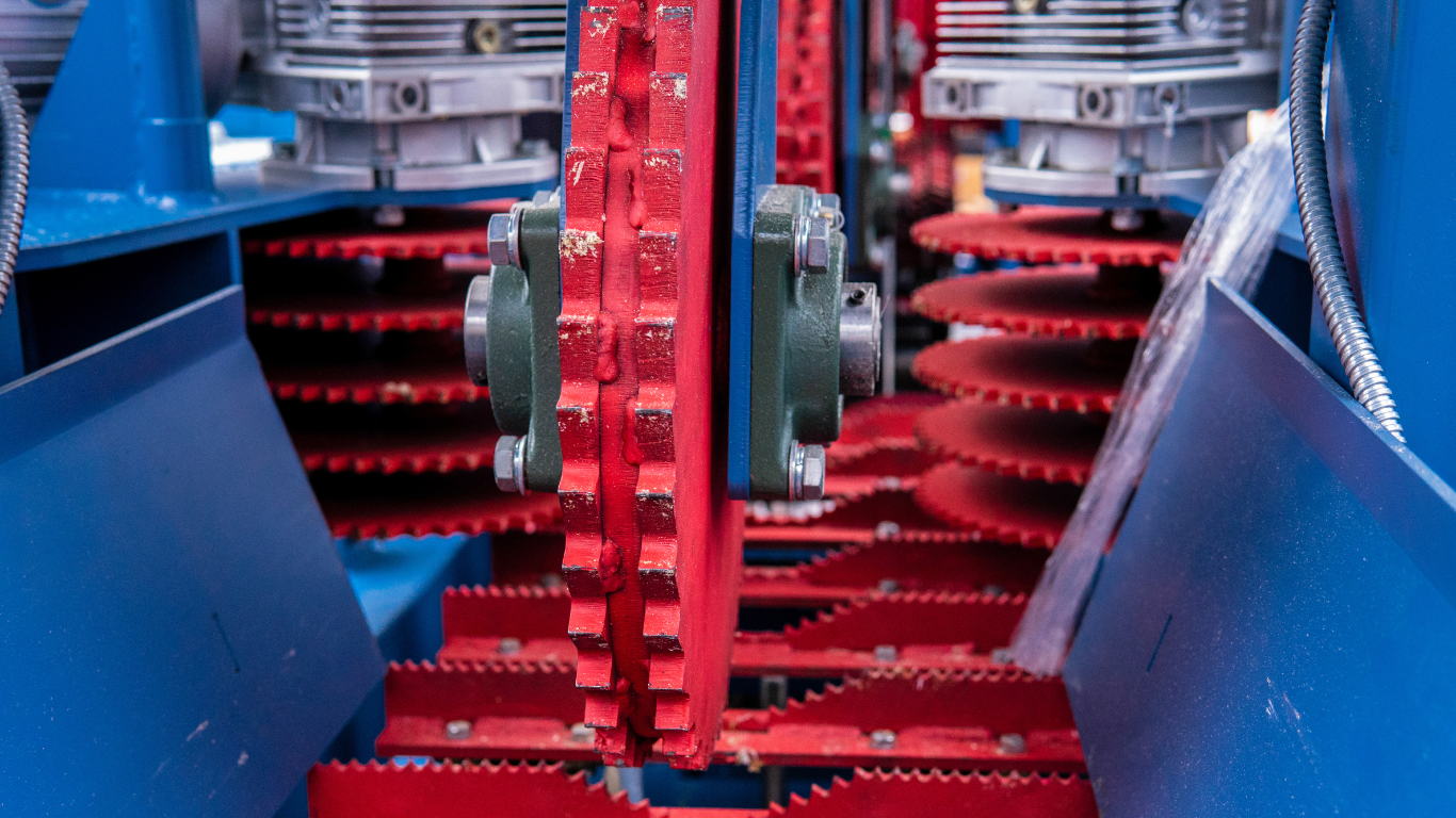 A close up of a machine with red and blue gears.
