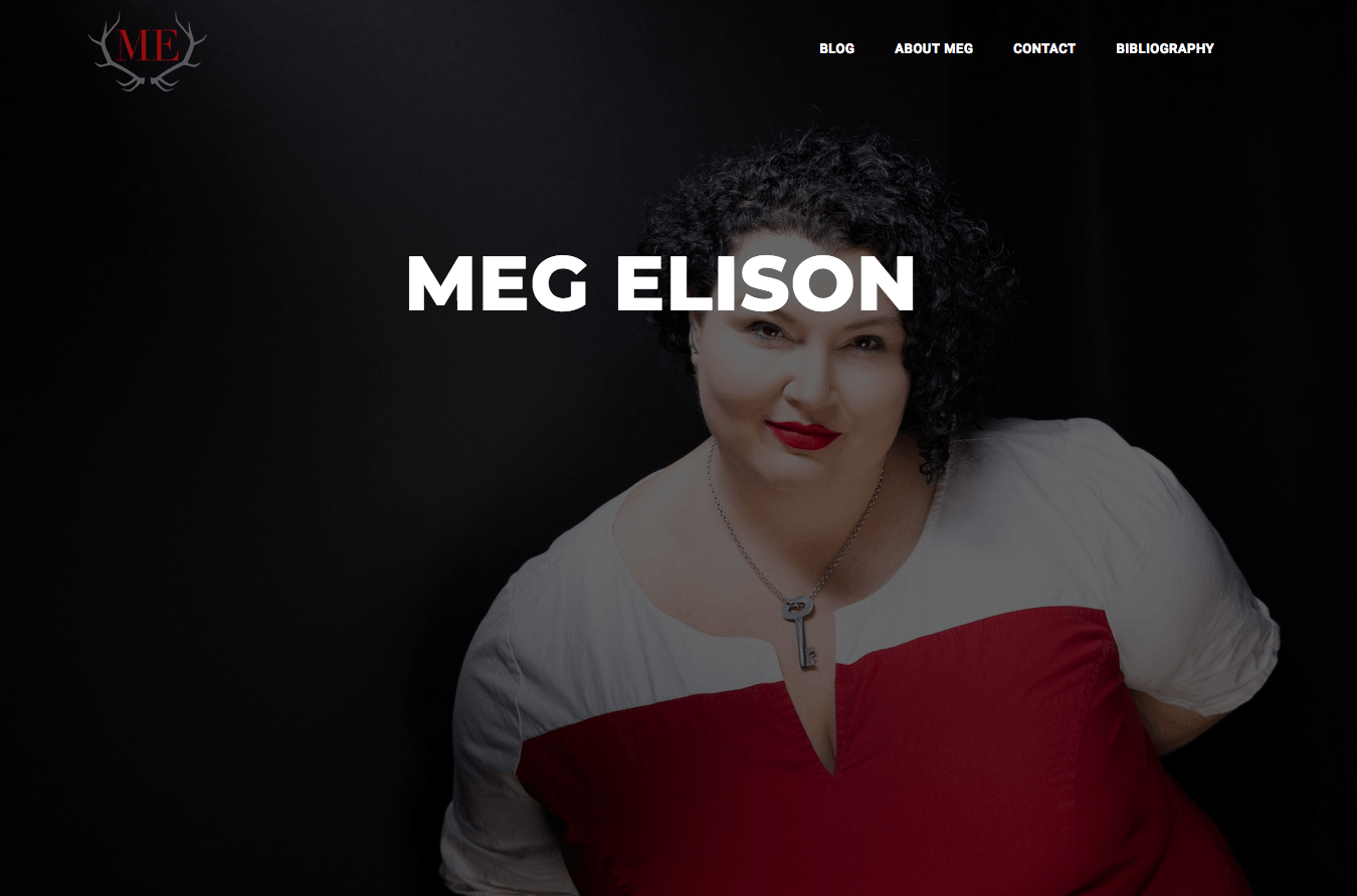 Meg Elison, smiling with red lipstick, wearing a white shirt and red top, against a black backdrop.