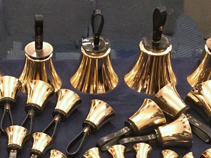 A choir is singing in front of a crowd of people in a church.