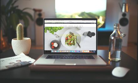 A laptop with a picture of a salad on the screen