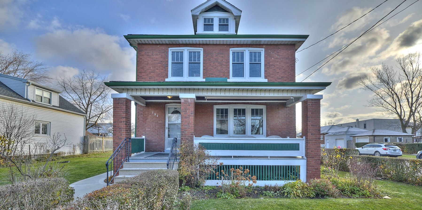 A captivating view of a quaint and charming all red brick residential home.