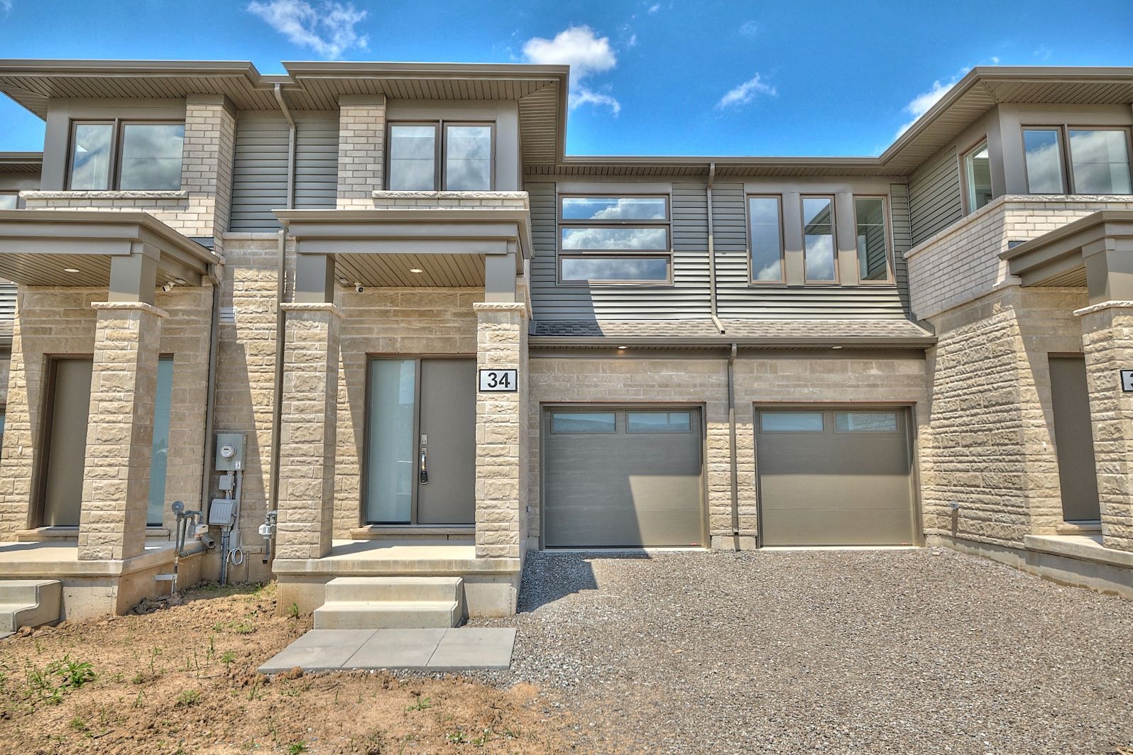 Backing onto a stream with no rear neighbors, this brand-new, modern townhouse by Mountainview Homes.