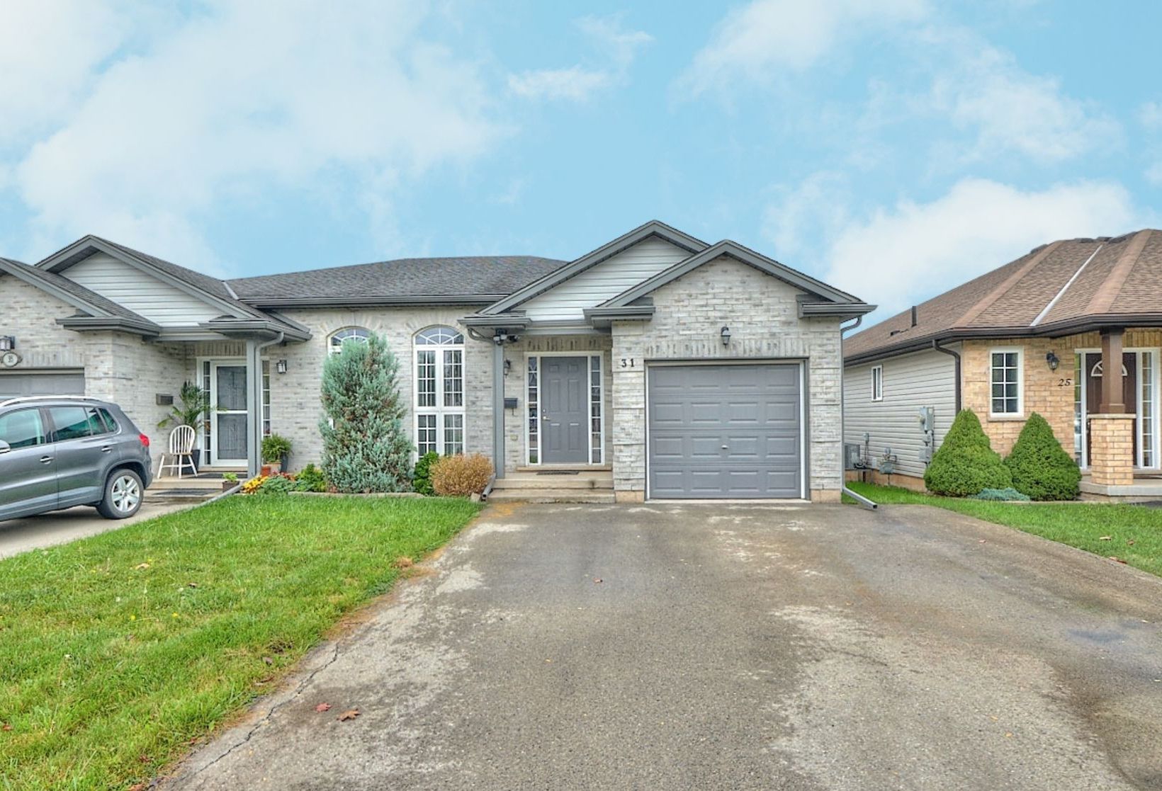 a grey brick semi-detached raised bungalow in Welland, Ontario.