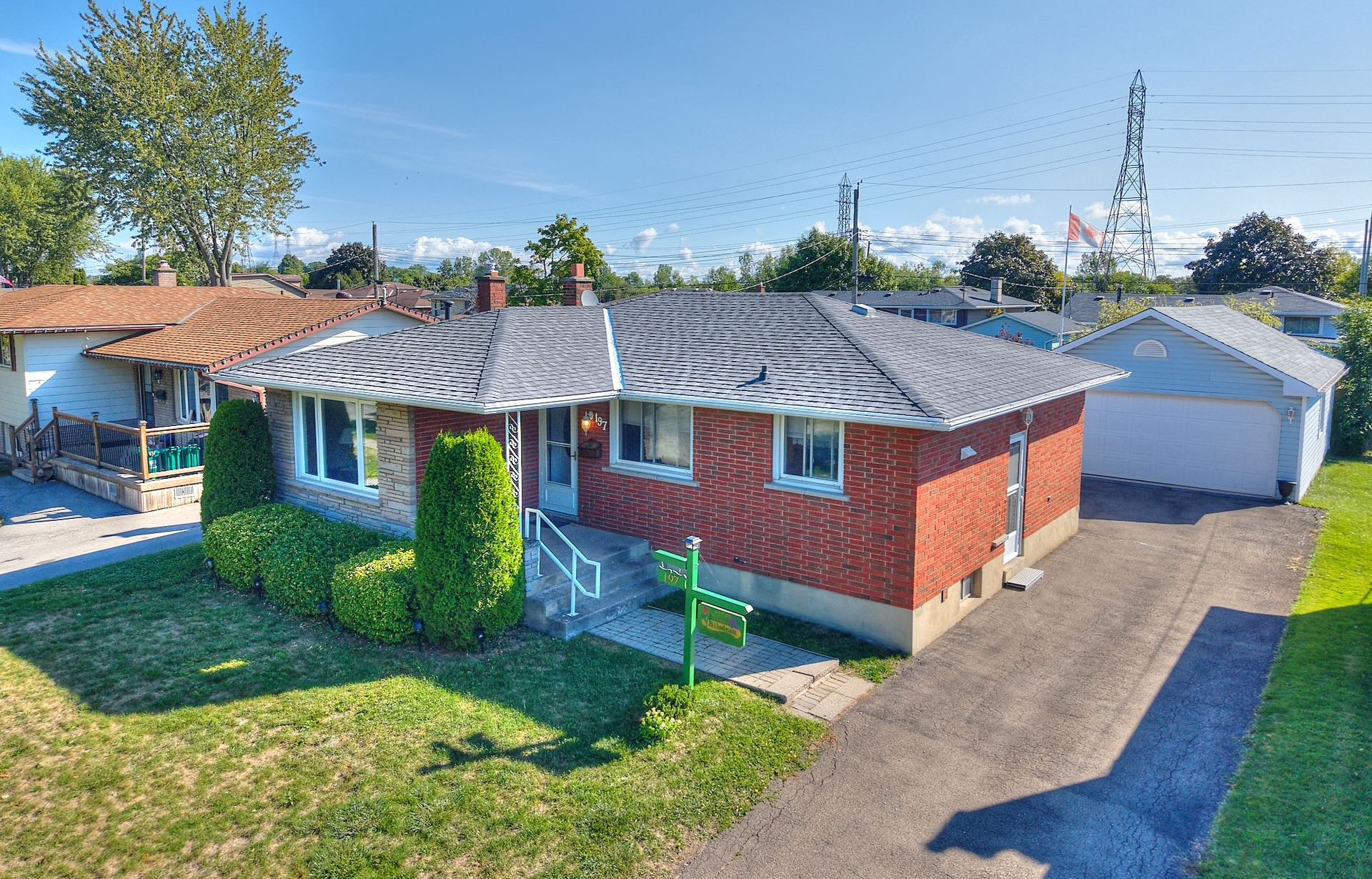 A brick detached bungalow with an oversized garage.