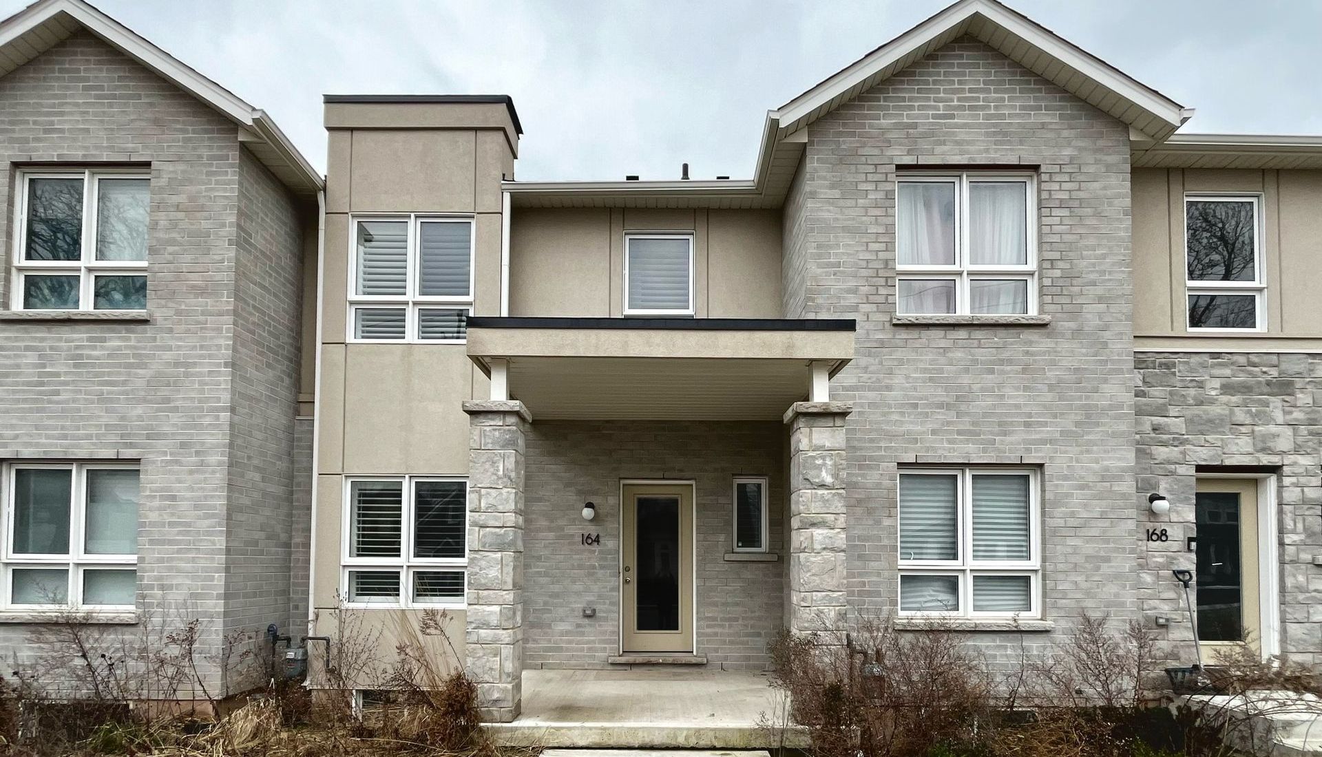 A picture of a townhouse home with a grey exterior