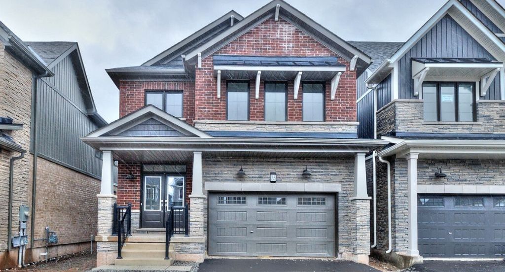 The interior of a detached two-storey home in Welland, Ontario with modern furniture and appliances. And blue decor accents.