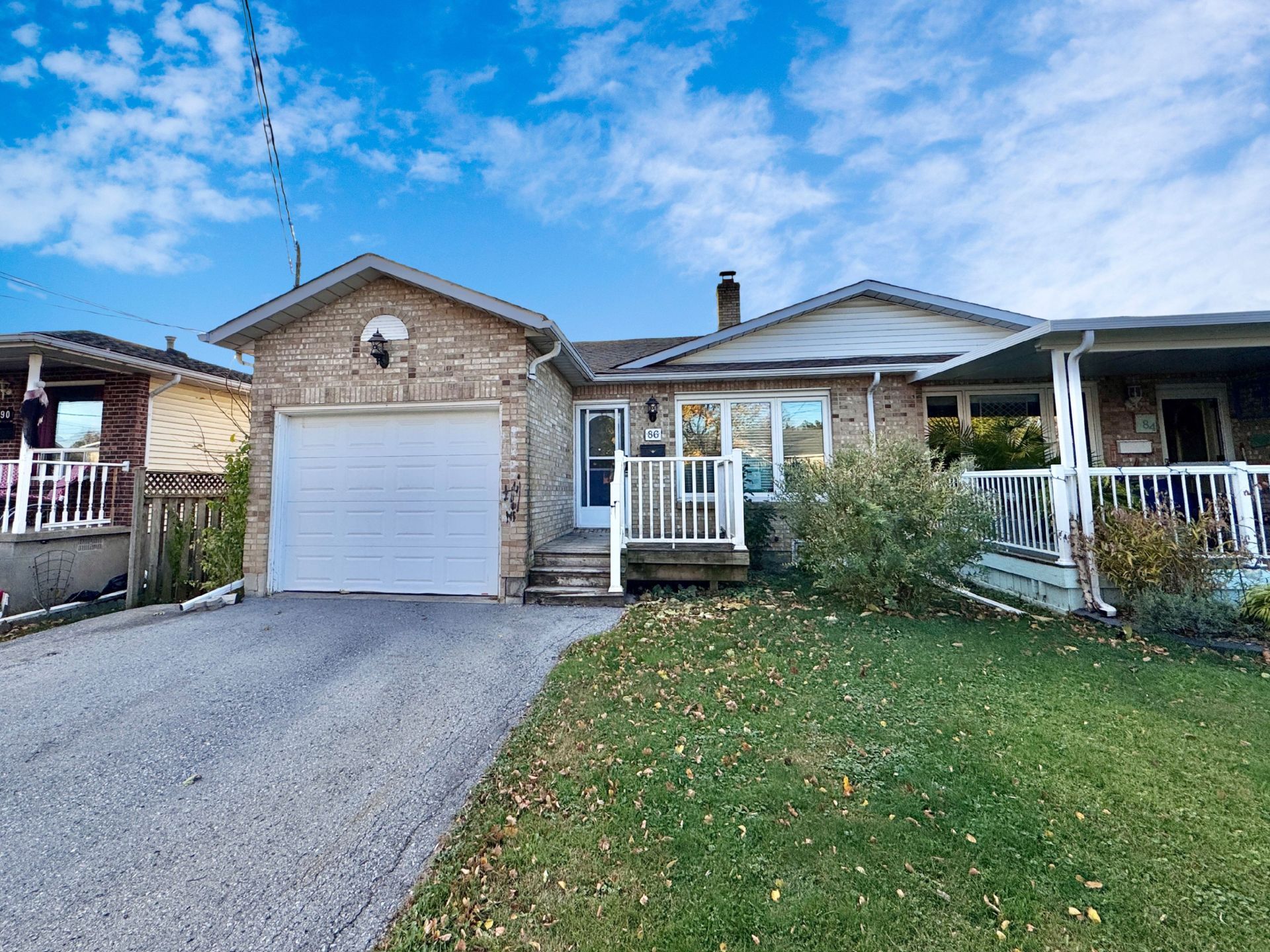 A semi-detached bungalow with an attached garage.