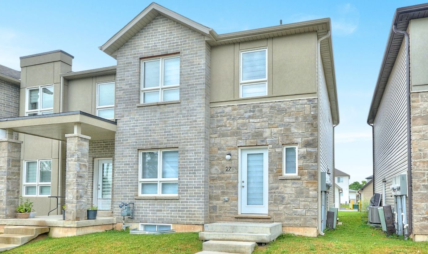 This two-storey townhouse features four bedrooms, four bathrooms, and a single-car detached garage behind the unit.