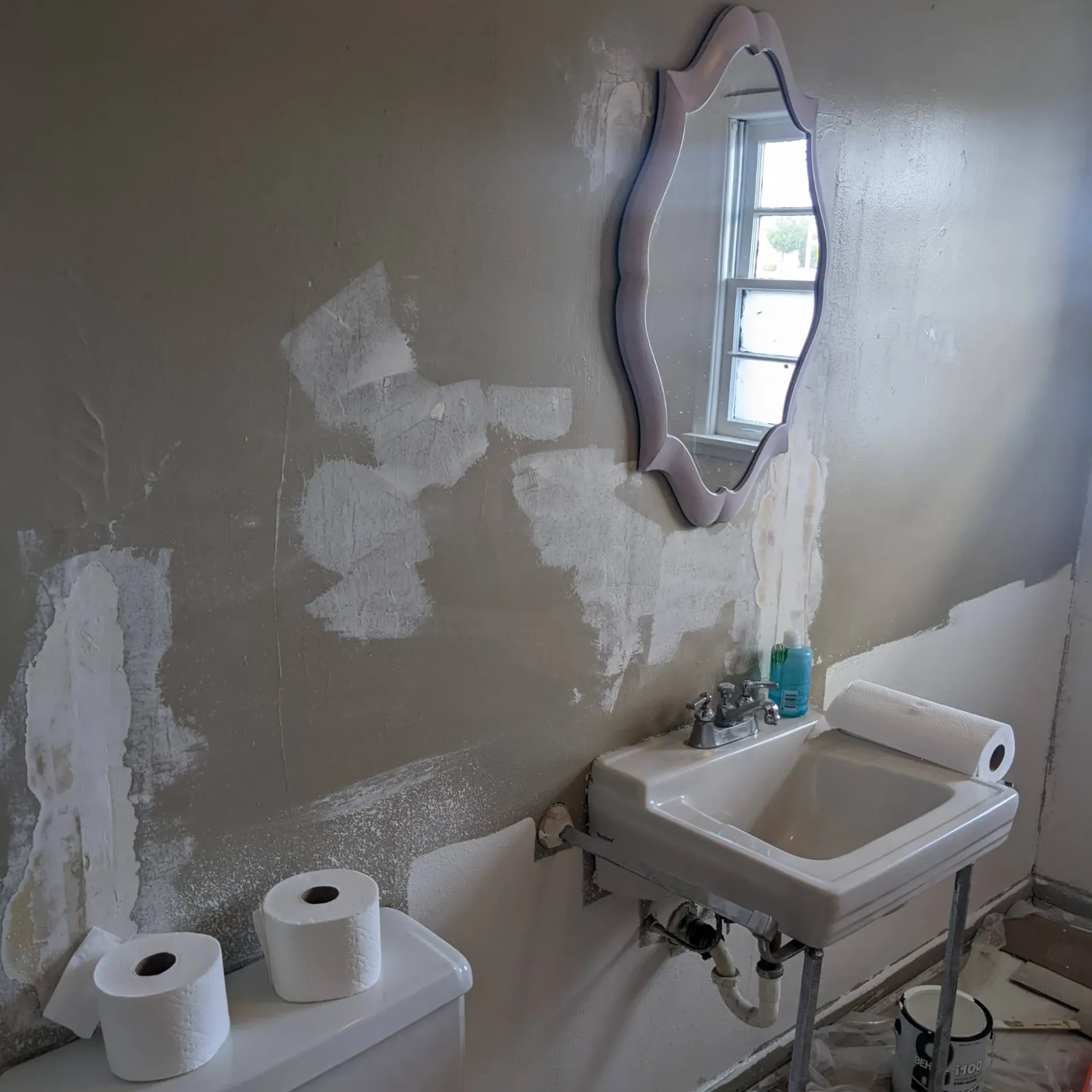 Aarons Repair and Remodel - A bathroom with a sink a toilet and a mirror