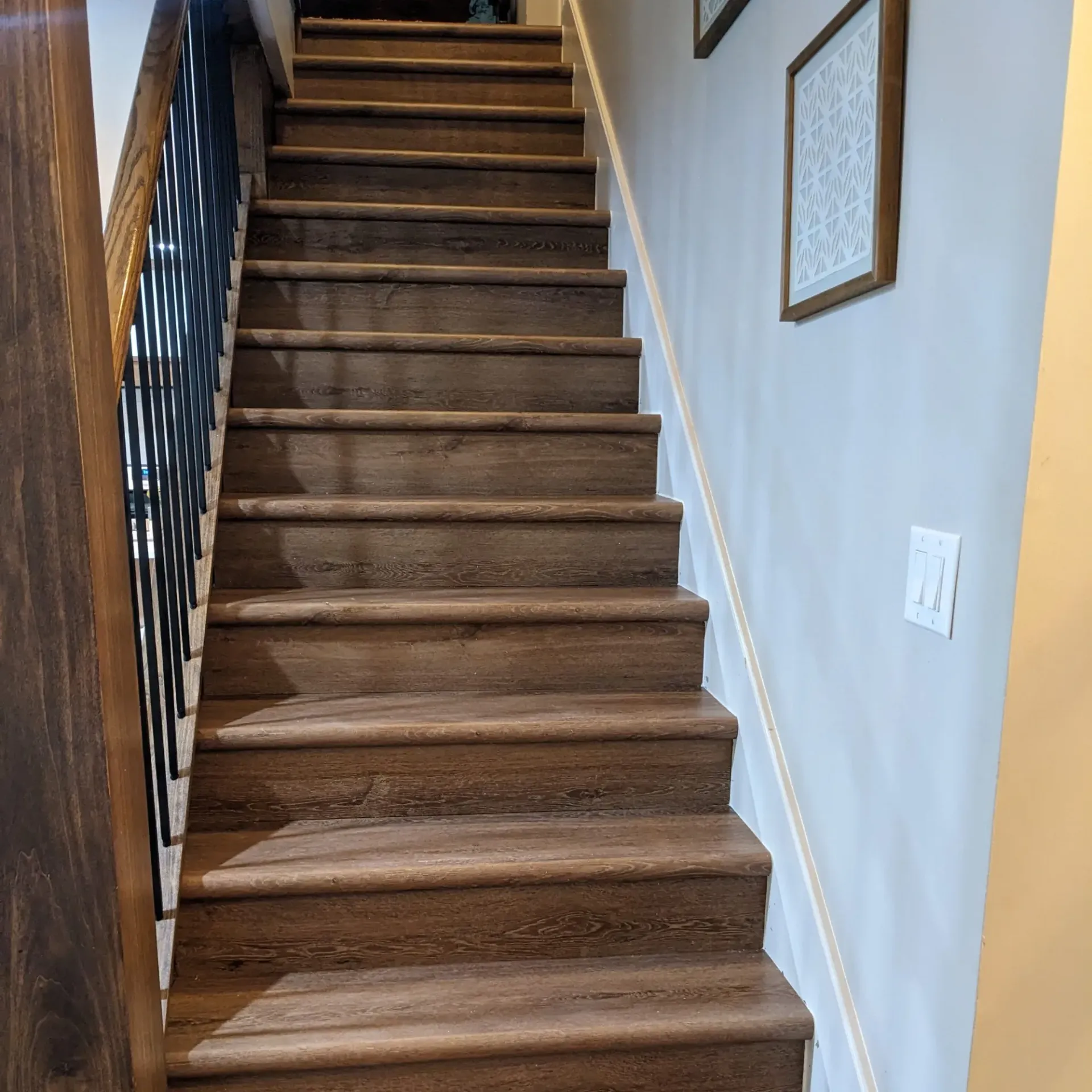 Aarons Repair and Remodel - A set of wooden stairs leading up to the second floor of a house.