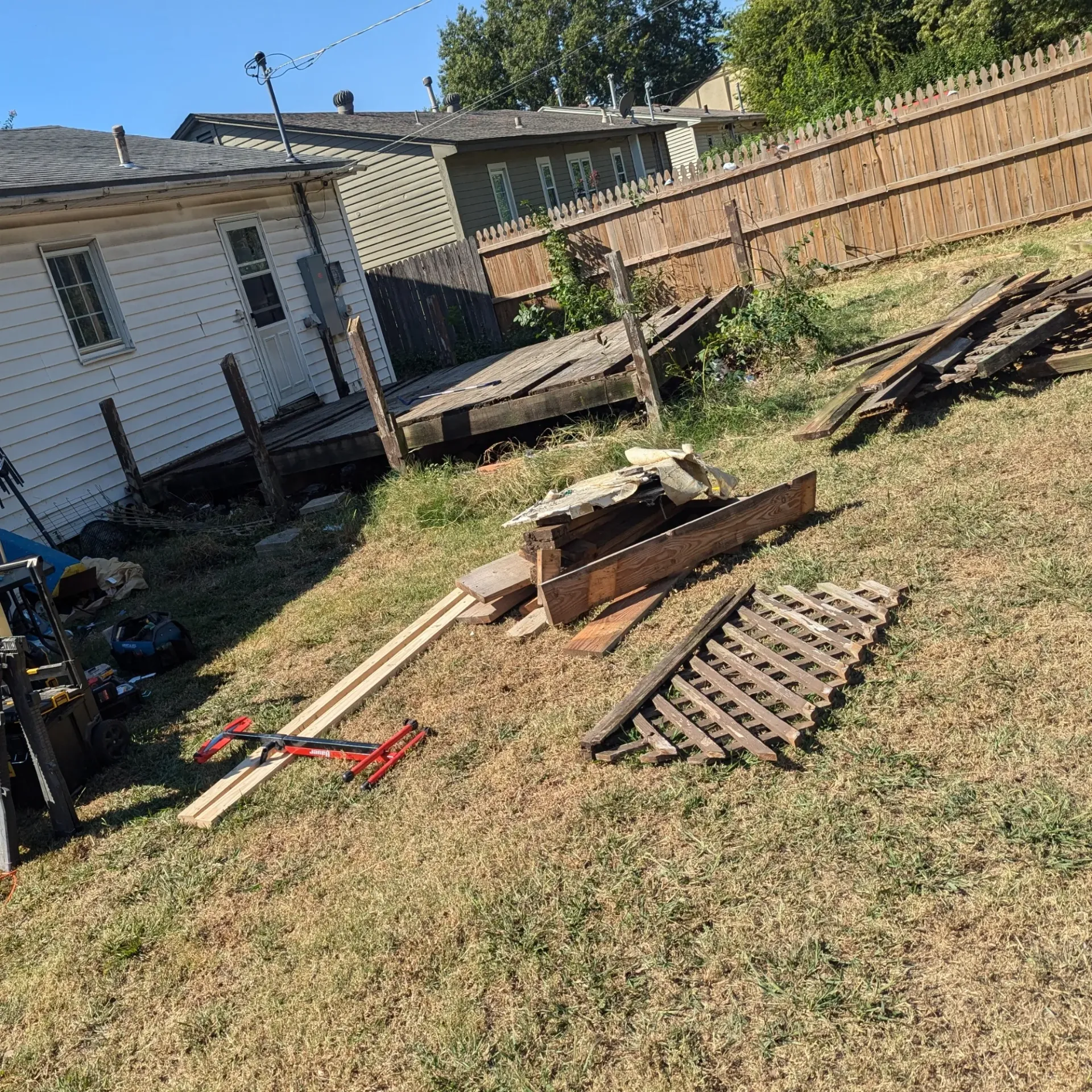 Aarons Repair and Remodel - A wooden deck is being built in the backyard of a house.