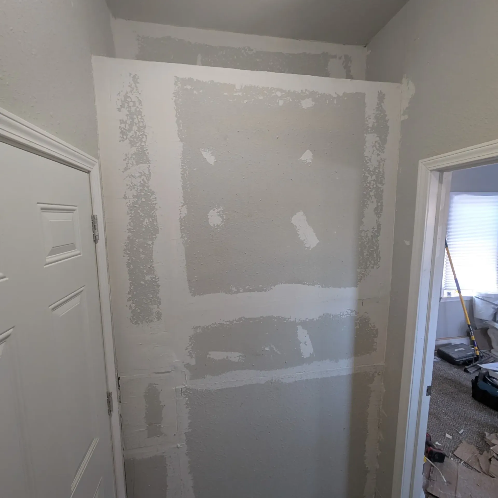 Aarons Repair and Remodel - A room with a door and a wall that is being remodeled.