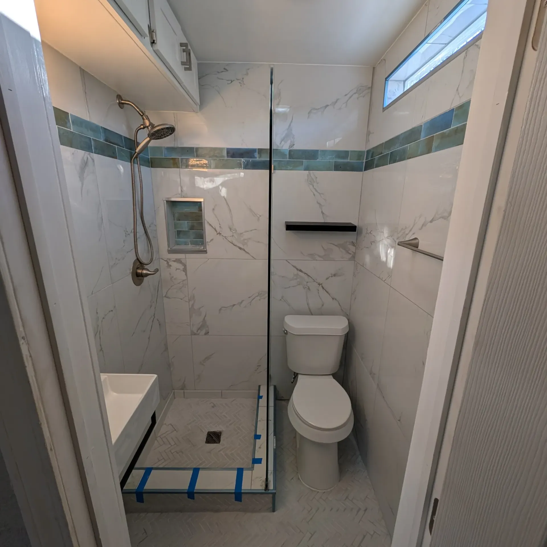 Aarons Repair and Remodel - A bathroom with a toilet , sink and shower.