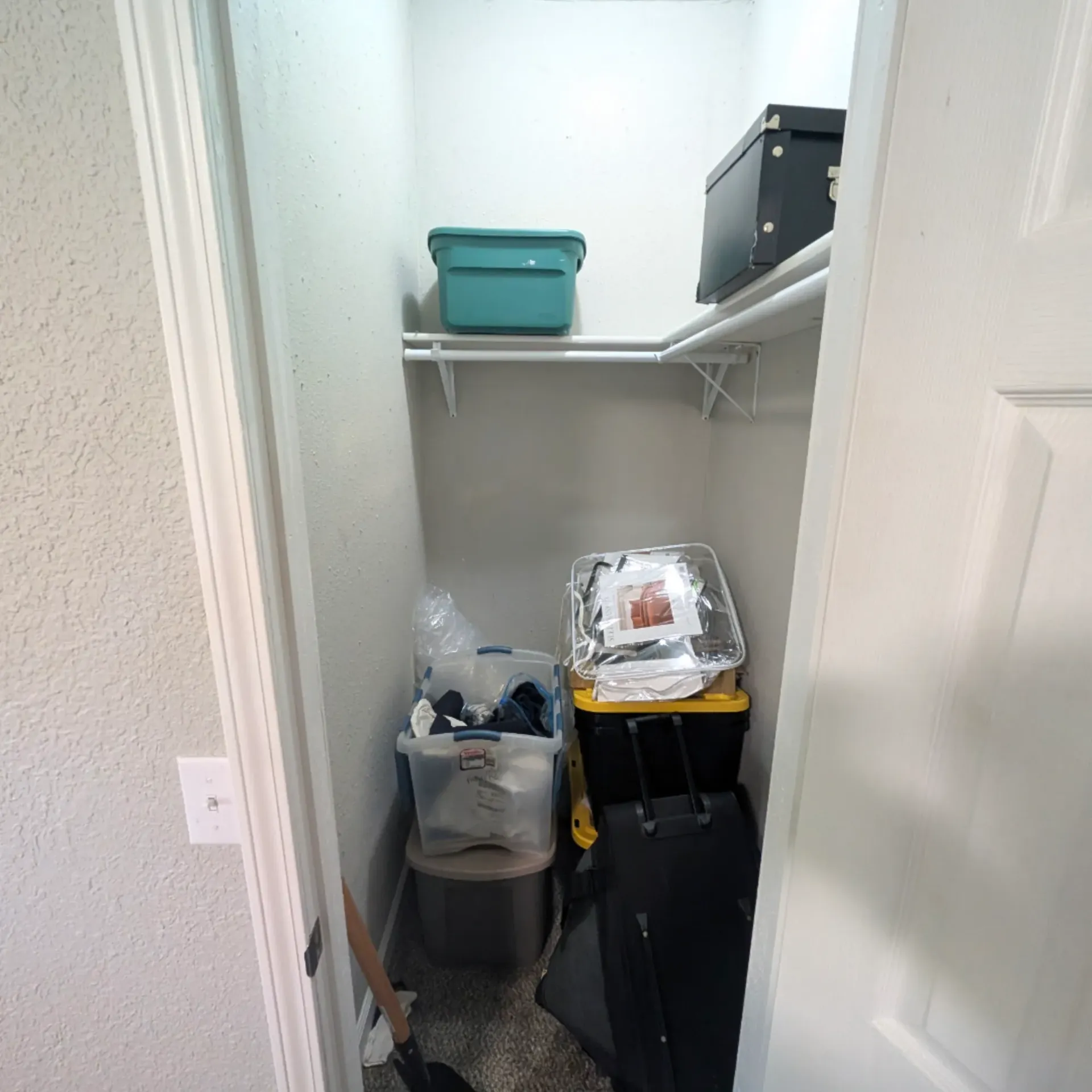 Aarons Repair and Remodel - A small closet filled with boxes and a suitcase