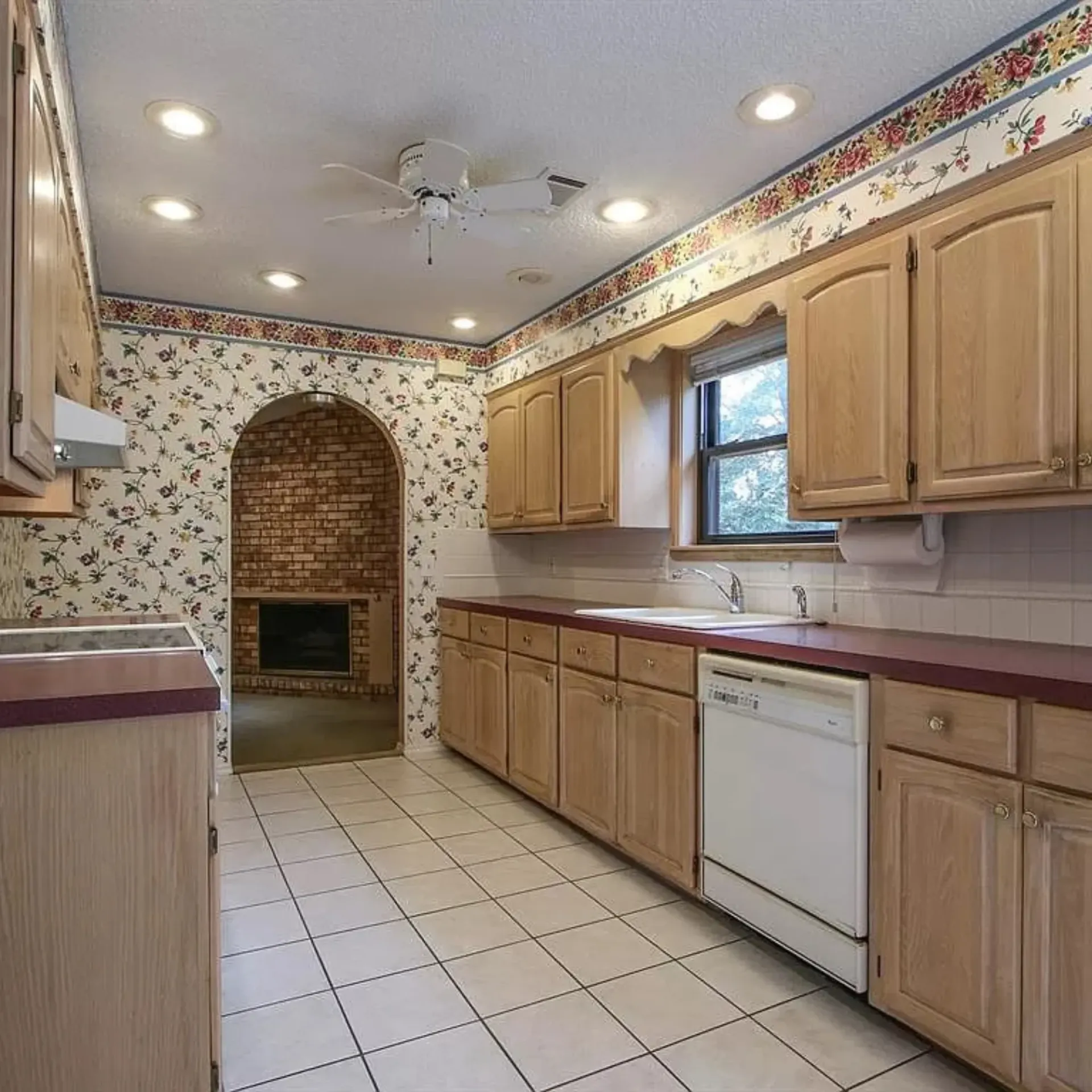 Aarons Repair and Remodel - A kitchen with wooden cabinets and a white dishwasher