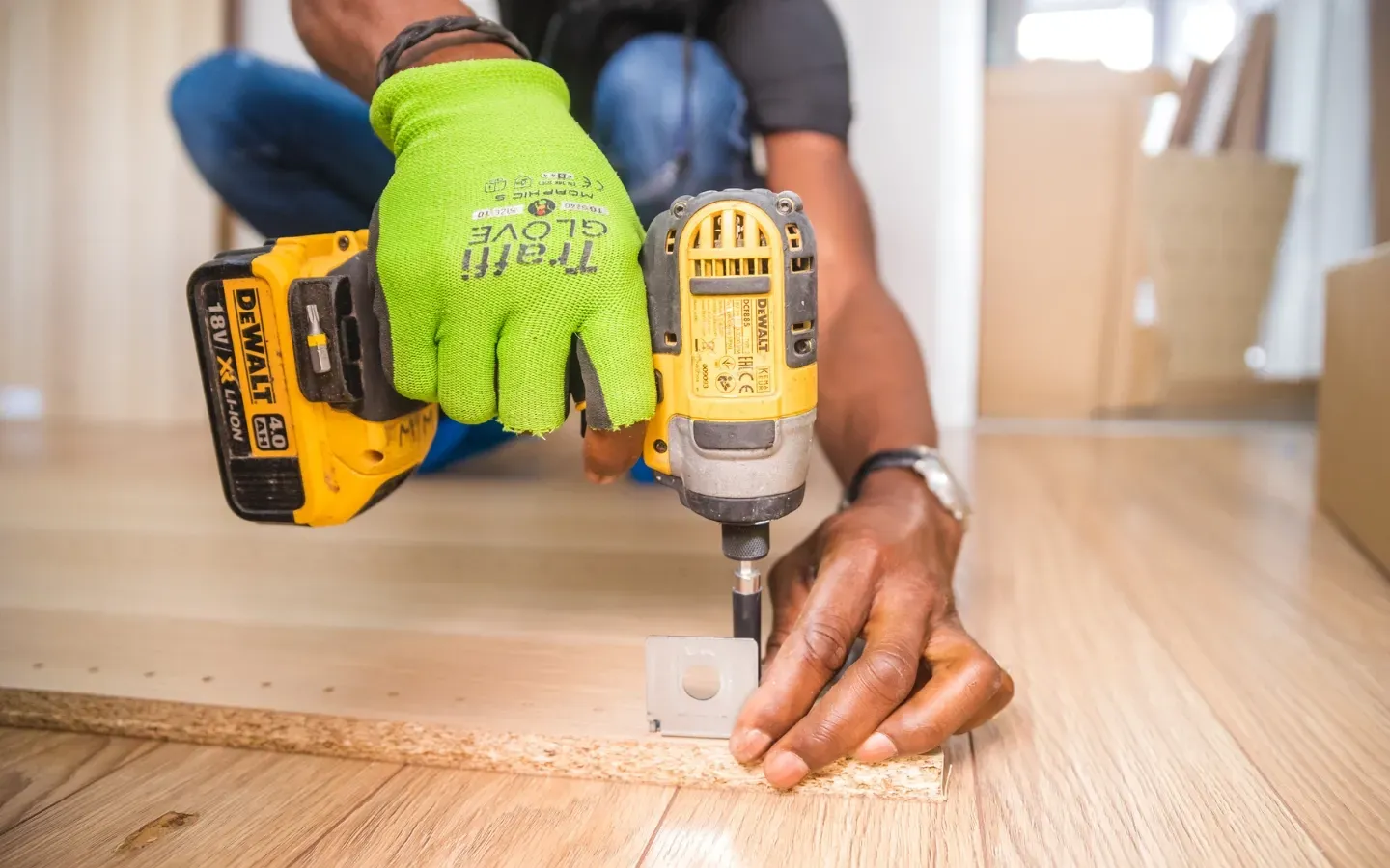 Aarons Remodel and Repair - A man is using a drill to drill a hole in a piece of wood.