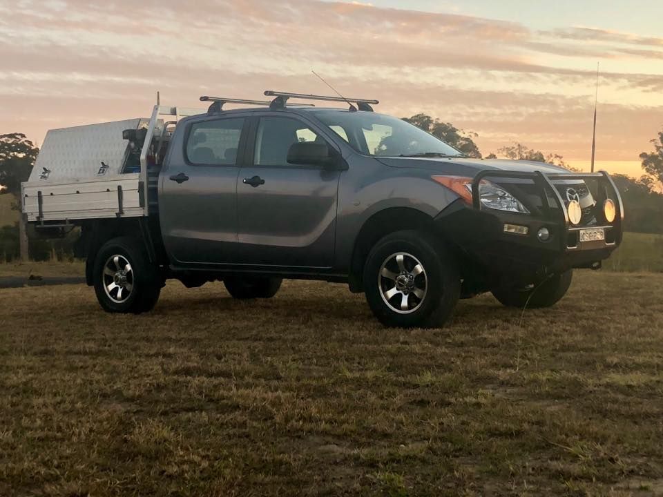 A Truck With a Tray on the Back is Parked in a Field — East Coast Mechanic in Nambucca Heads, NSW