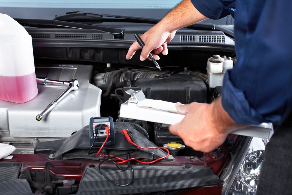 A Man is Working on the Engine of a Car — East Coast Mechanic in Urunga, NSW