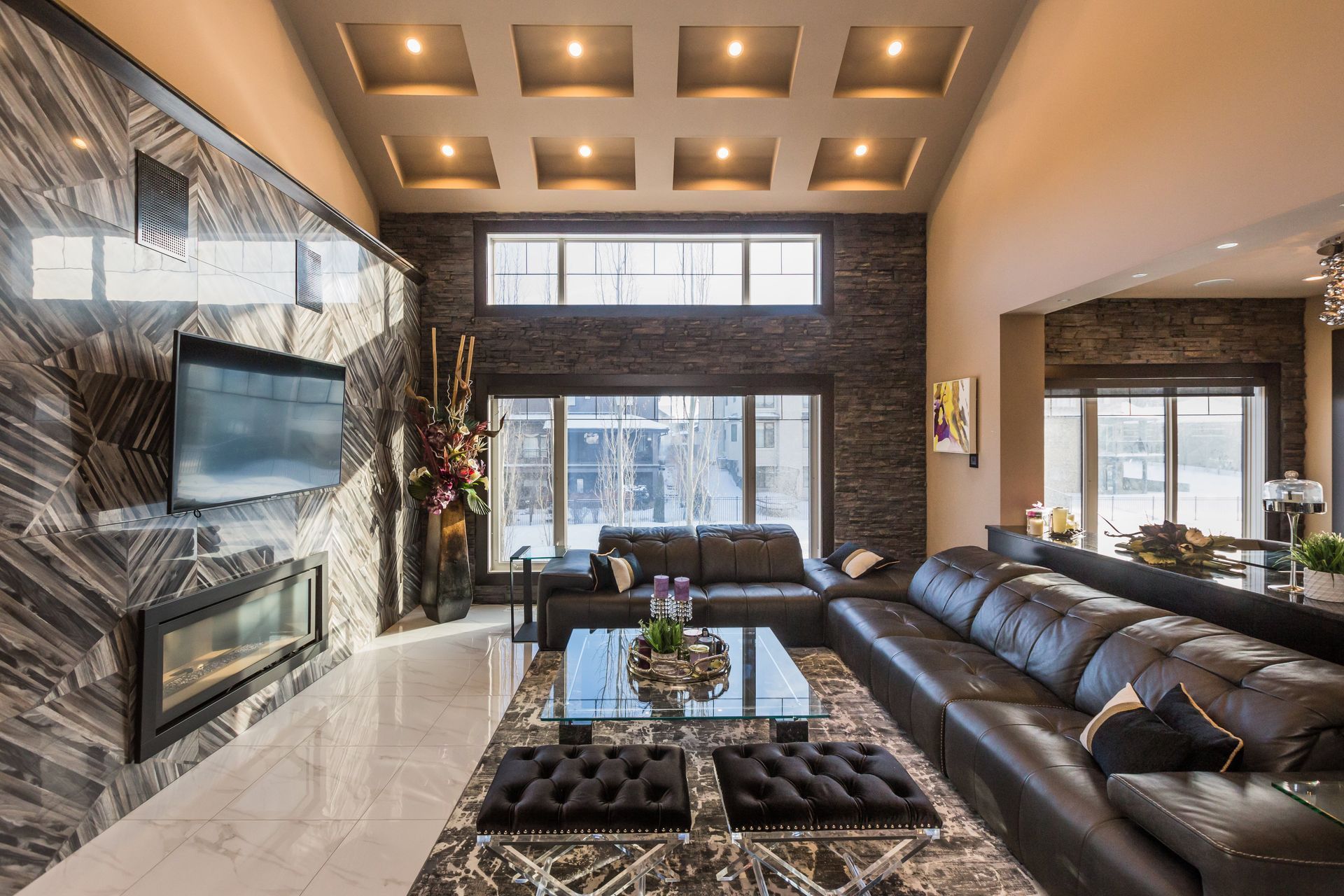 A living room with a couch , fireplace and television.
