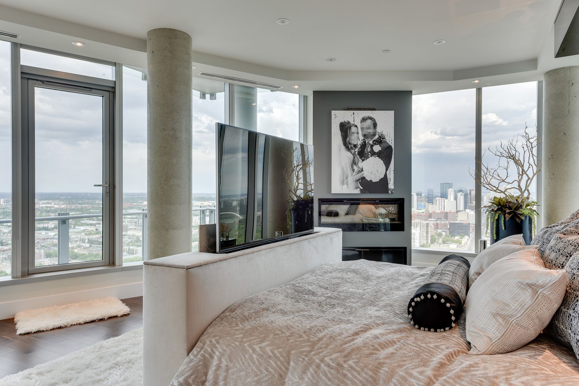 A bedroom with a large bed and a flat screen tv.