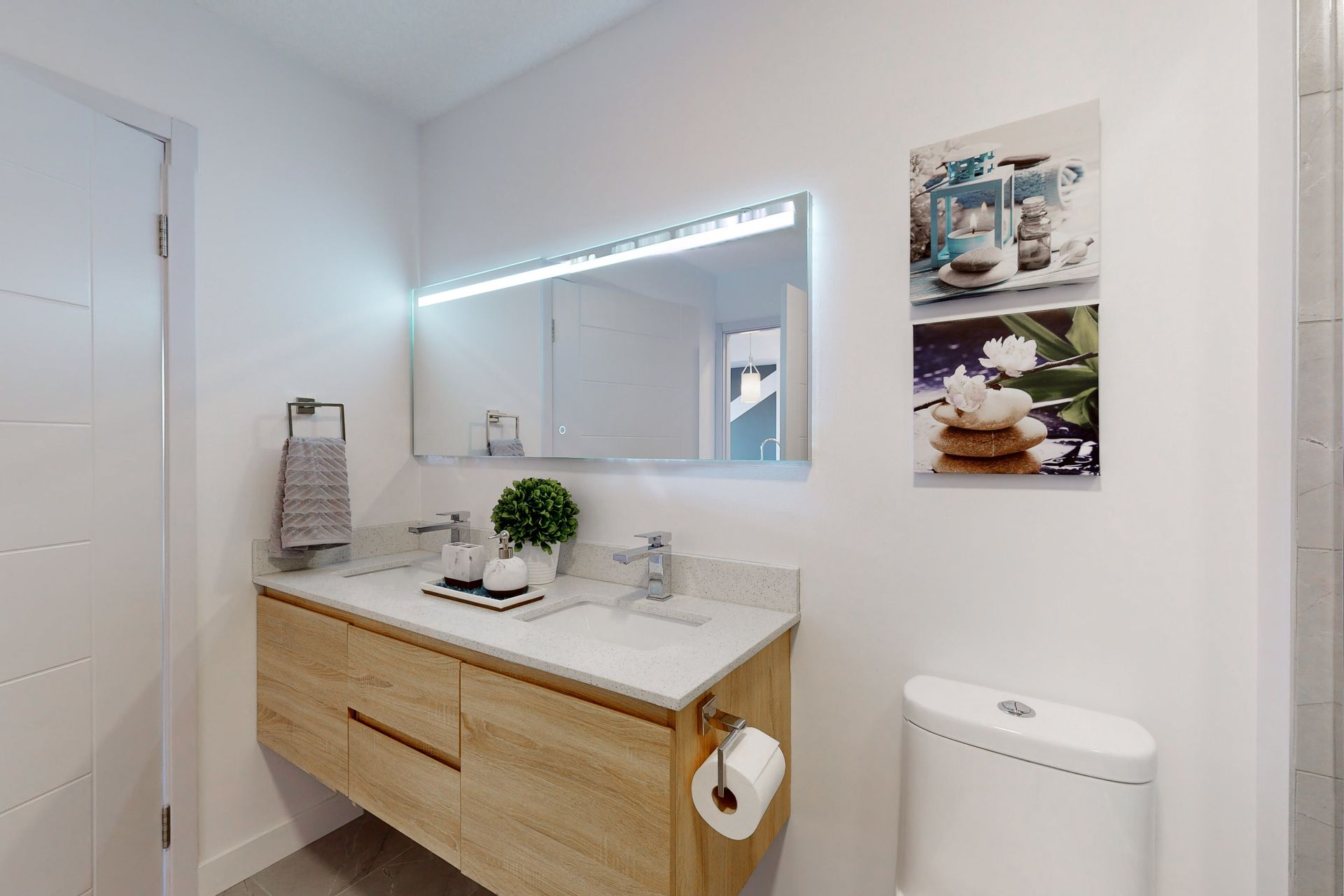 A bathroom with a sink , toilet and mirror.