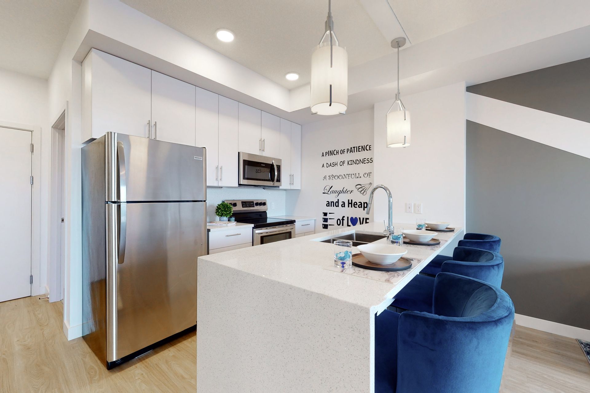 A kitchen with stainless steel appliances and a large island.