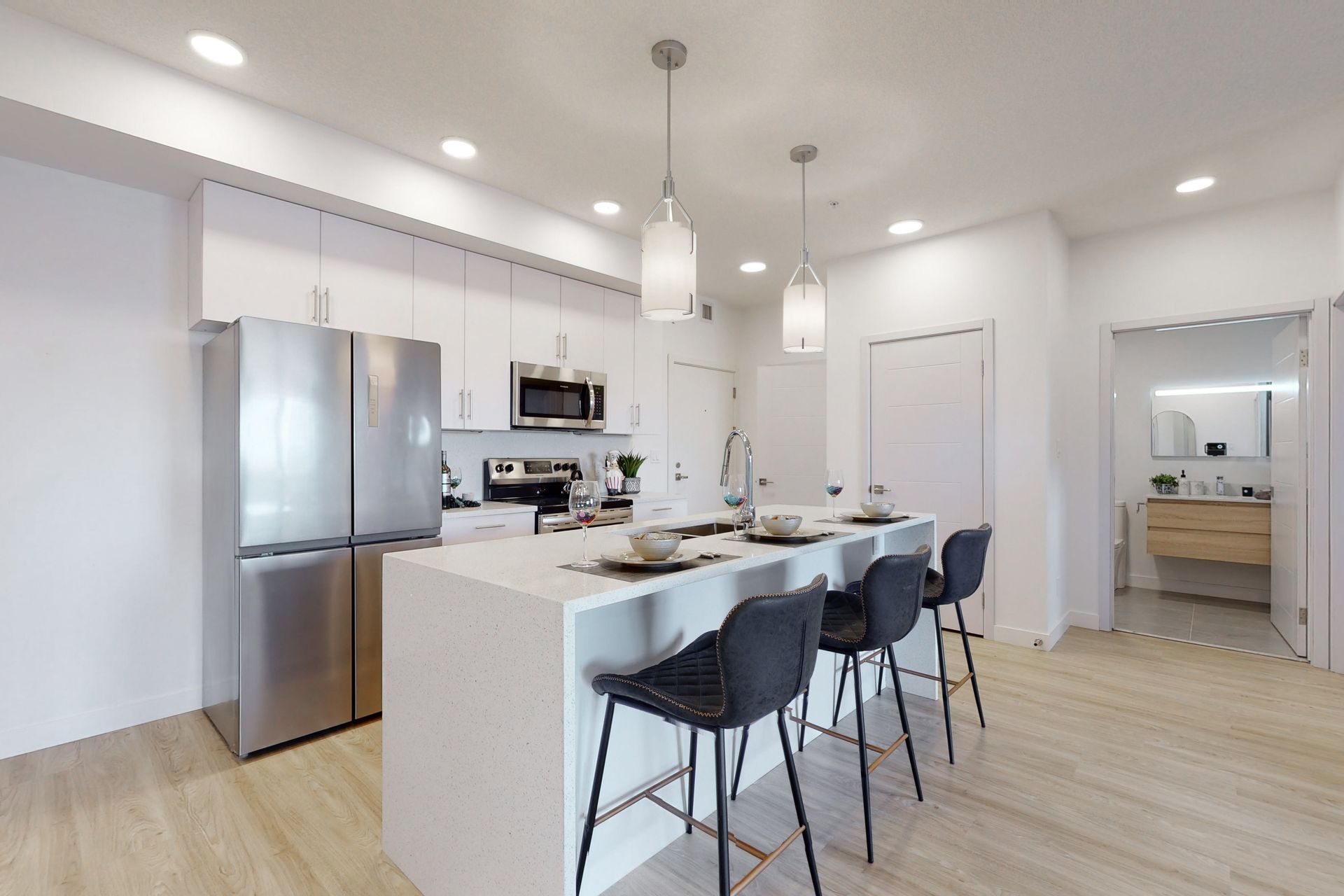 A kitchen with a large island and stools