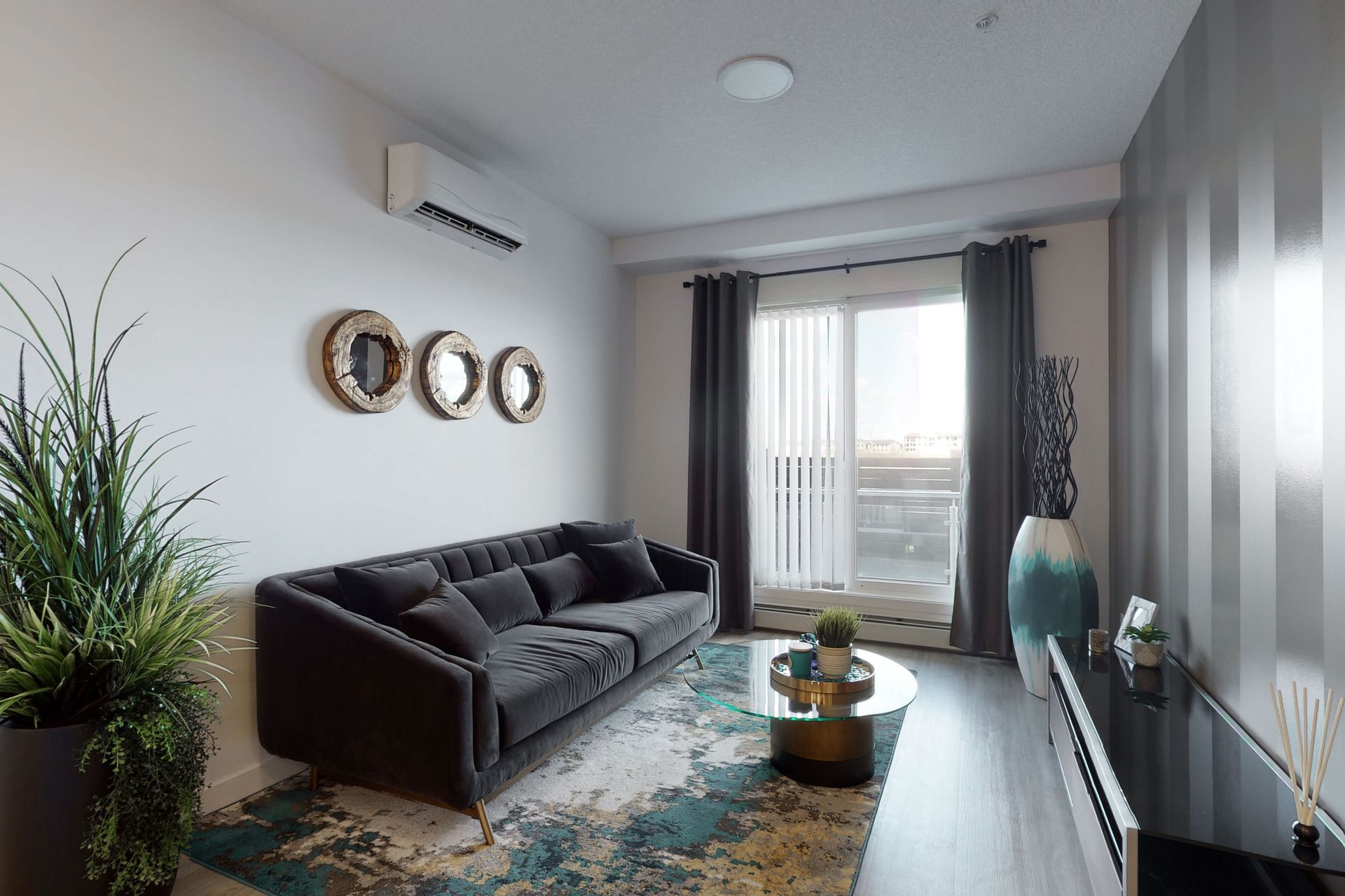 A living room with a couch , coffee table , and window.