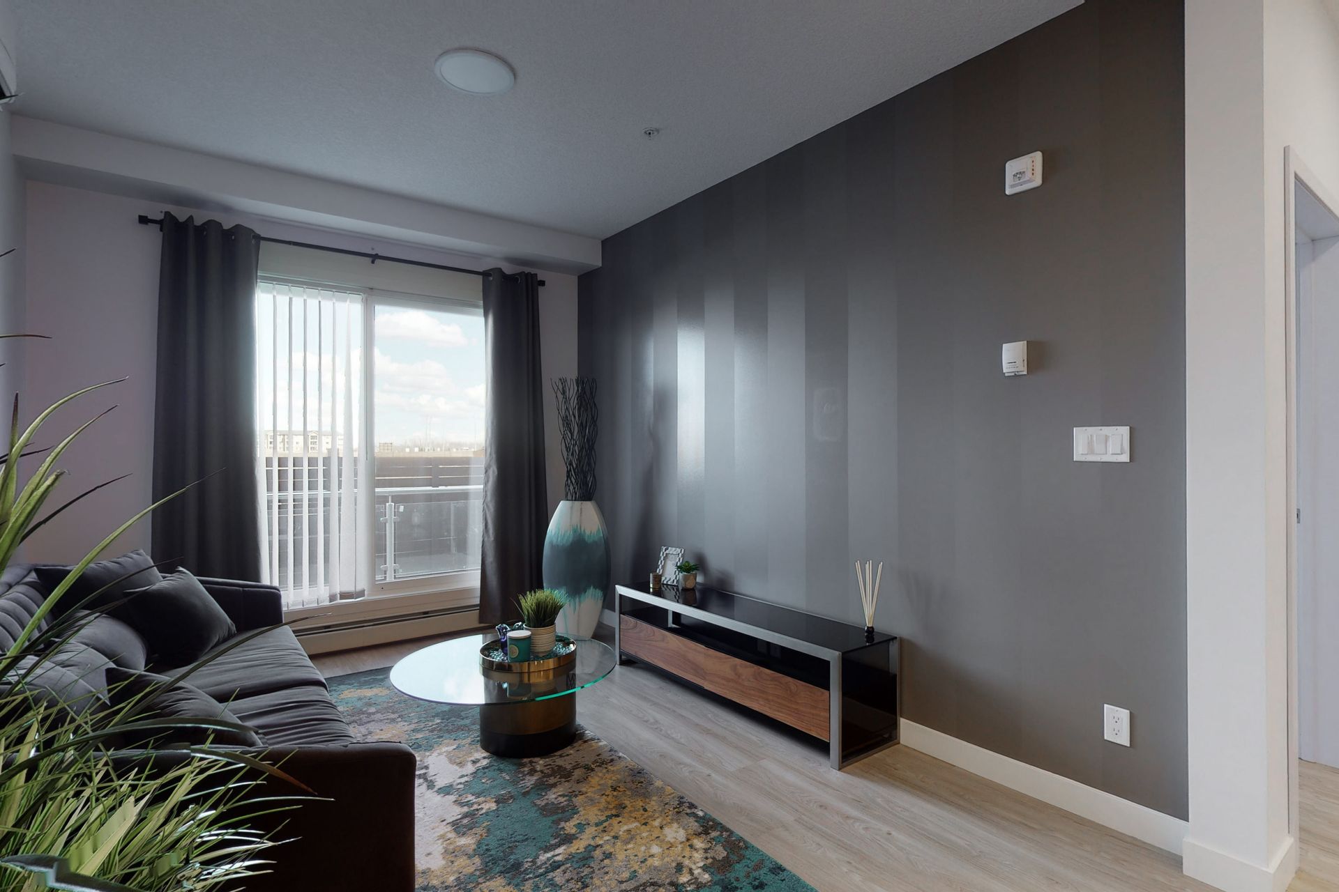 A living room with a couch , table , and television.