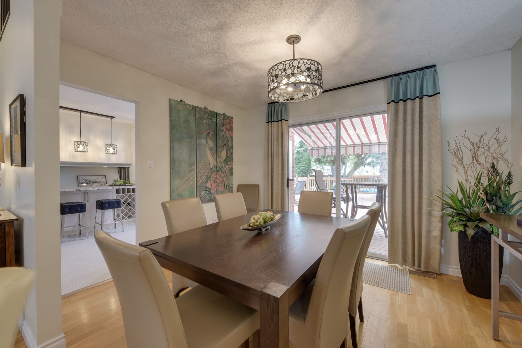 A dining room with a table and chairs and a chandelier.