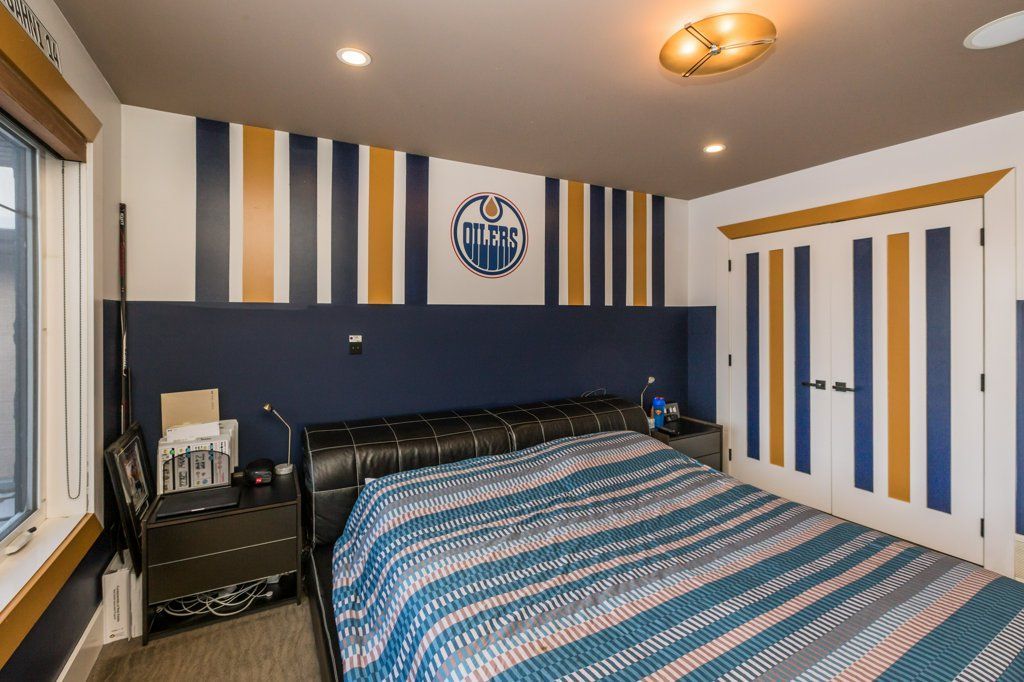 A bedroom with a large bed and striped walls.