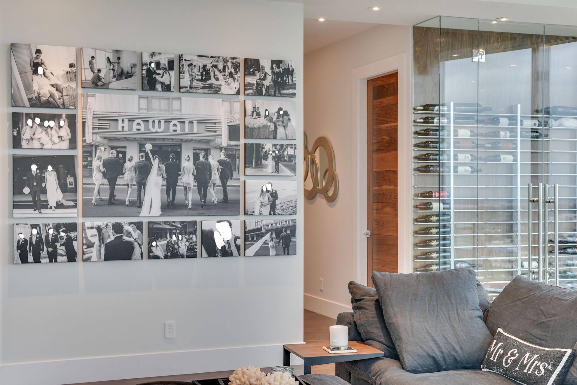 A living room with a couch and a collage of pictures on the wall