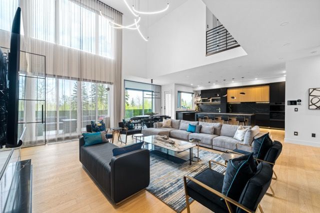 A living room with a couch , chairs , and a television.
