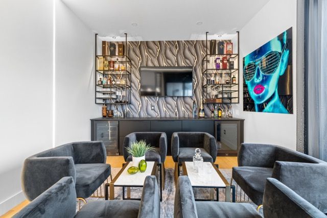A living room with a painting of a woman on the wall