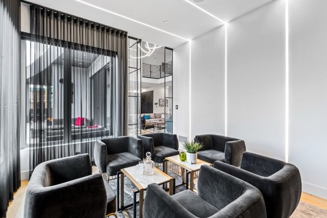 A living room with a lot of chairs and tables