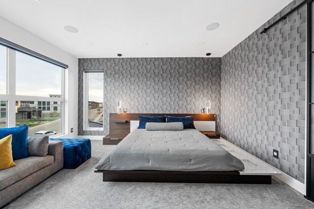 A bedroom with a bed , couch , and window.