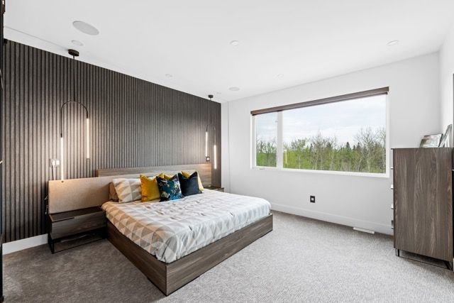 A bedroom with a large bed and a large window.