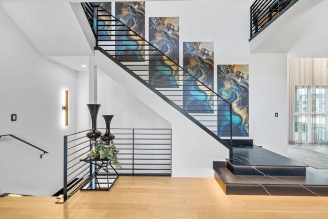 A staircase in a house with paintings on the wall