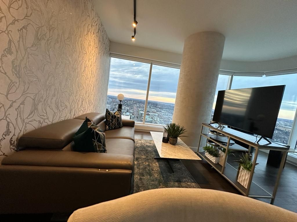 A living room with a couch , table , and television.