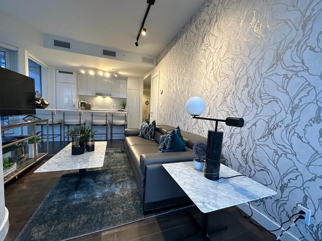 A living room with a couch , table , and television.