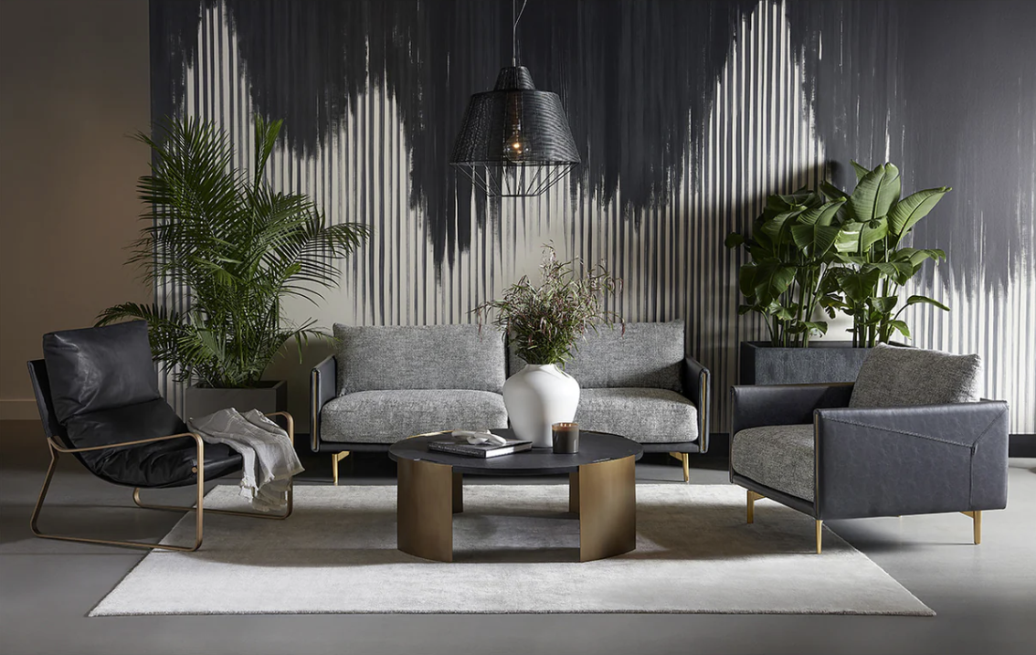 A living room with a couch , two chairs , and a coffee table.