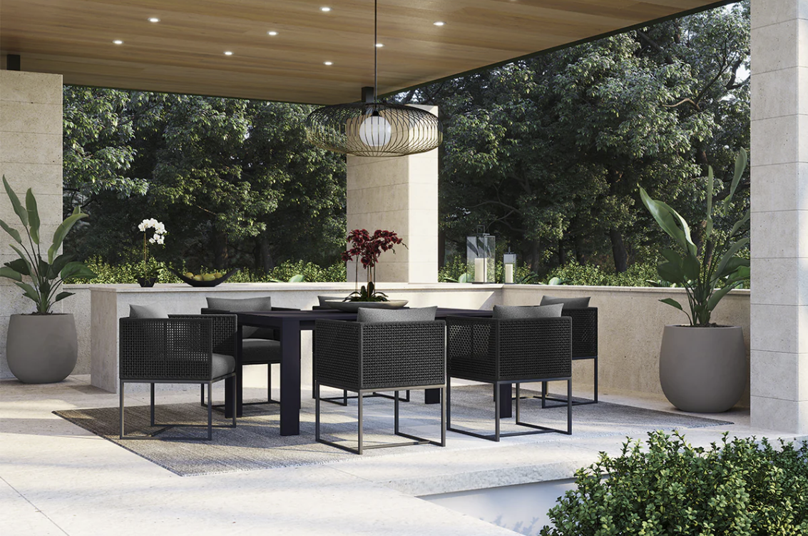 A patio with a table and chairs under a canopy