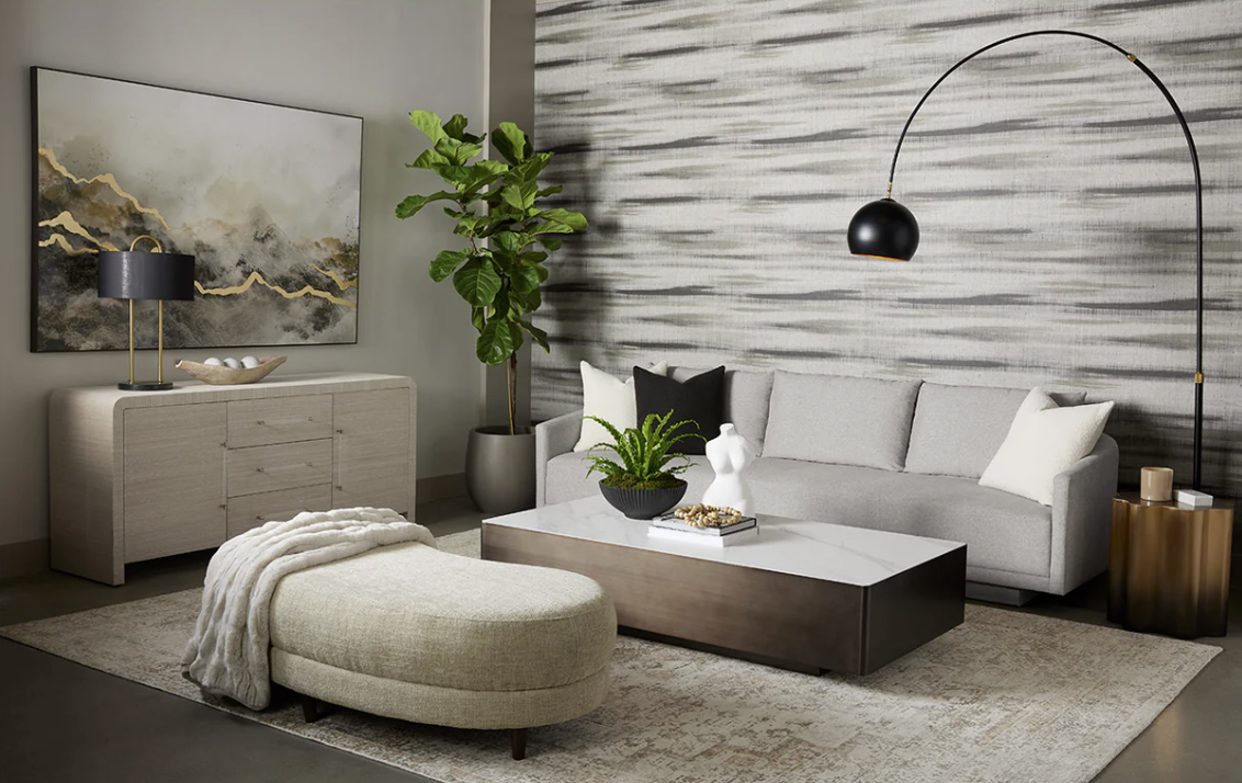 A living room with a couch , coffee table , and ottoman.
