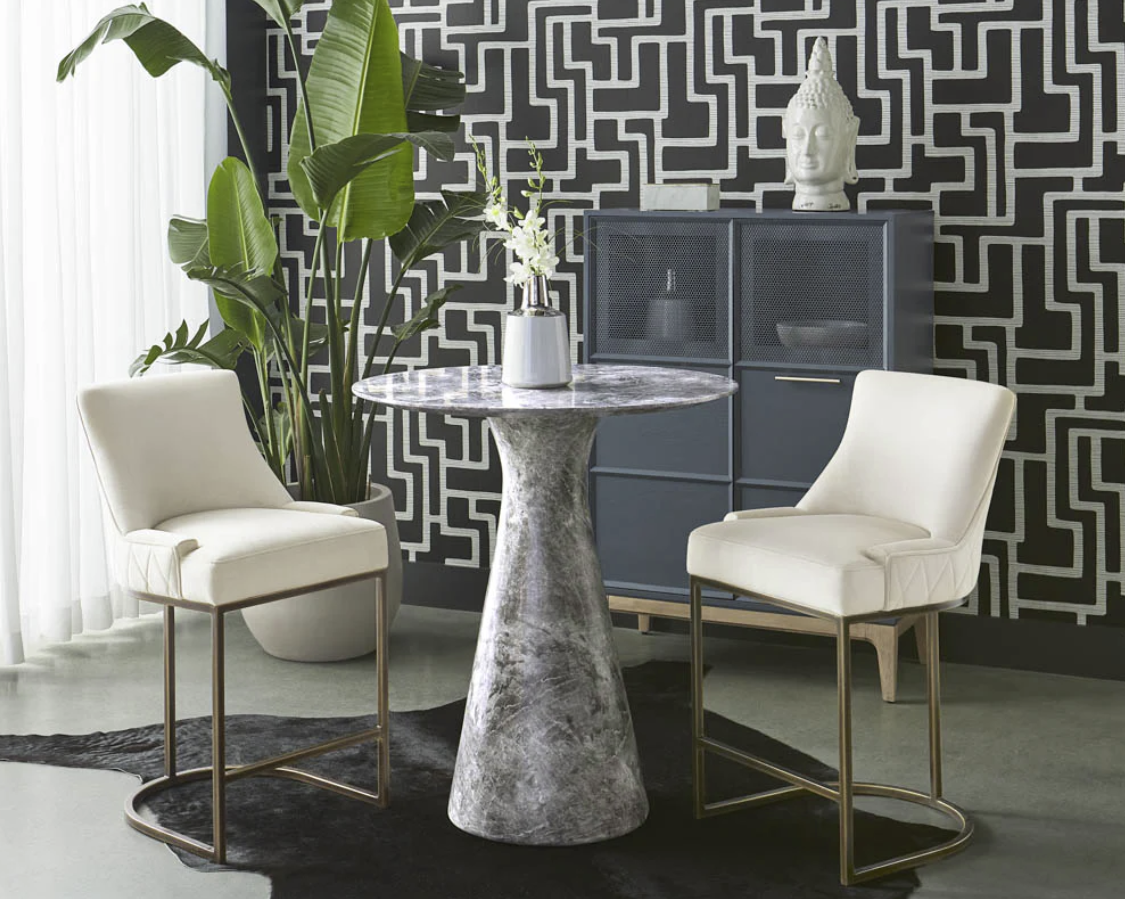 A table and chairs in a room with a black and white wall.