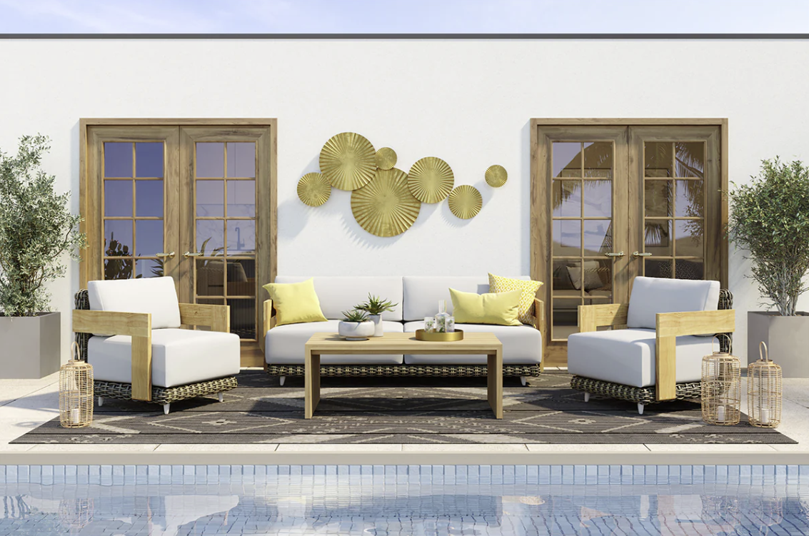 A patio with a couch , chairs , and a coffee table next to a pool.